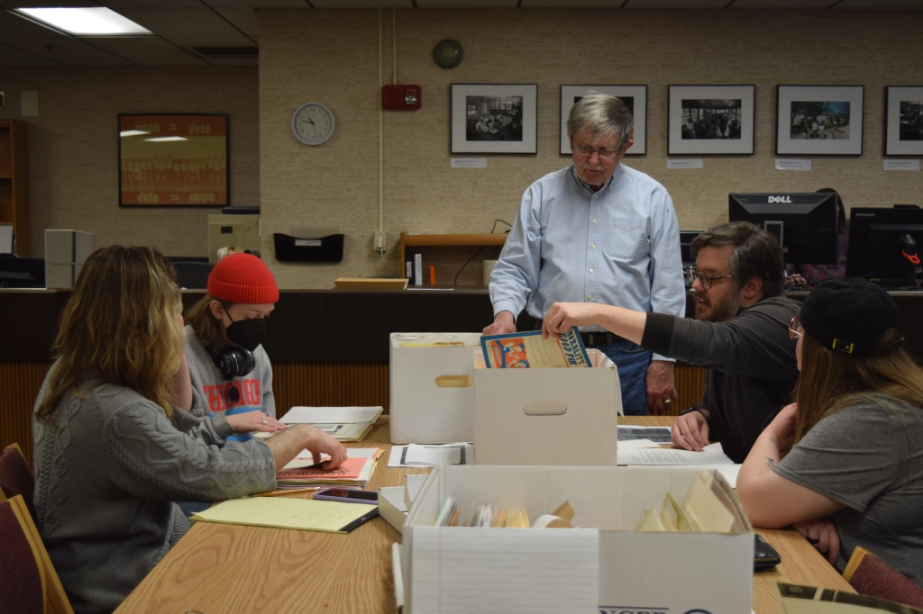 David Williams sifts through boxes of archival material with curatorial students in Archives and Special Collections.